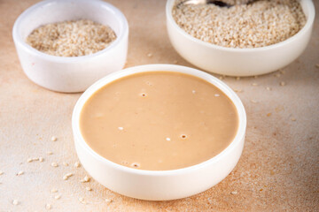 Tahini with sesame seeds, oily sesame paste, source of healthy fats, snack or ingredient in Middle Eastern and Mediterranean foods