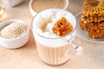Tasty sweet and salted tahini honeycomb latte. Hot coffee drink with whipped non-dairy creamer, tahini sesame paste, honey and honeycomb garnish