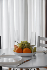 An Elegant Dining Setup Featuring a Fresh Fruit Arrangement for Enjoyment