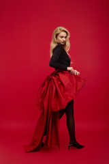 Blonde young woman in glamorous outfit celebrating the holiday season