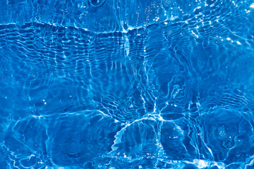 Blue water with ripples on the surface. Defocus blurred transparent blue colored clear calm water...