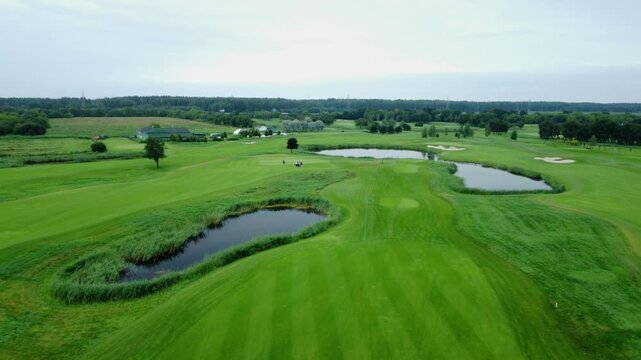 Drone view of golf course greens and lakes