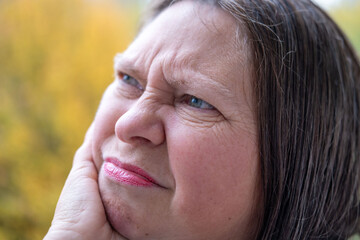 Woman covering ears with pained expression, Emotional portrait showing discomfort loud noise,...
