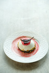 An exquisite dessert elegantly presented on a plate, featuring a delectable cake and artful sauce