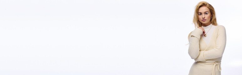 Beautiful young woman in cozy winter outfit on a bright white background