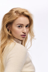 Fototapeta premium Winter elegance shines in a cozy knitted outfit with soft makeup tones