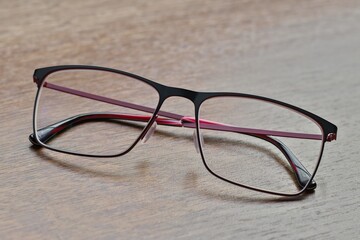 Glasses lying on the wooden table, close up