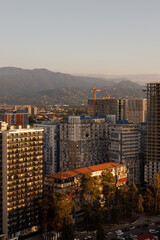 A beautiful urban landscape featuring modern architecture set against stunning mountains