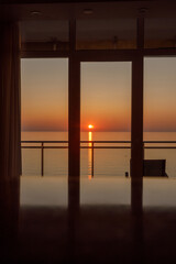 A Serene Sunset Gently Illuminating Calm Waters As Seen Through a Beautiful Glass Pane