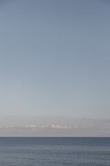 A Serene Horizon Stretching Over a Tranquil Sea Beneath a Beautiful Clear Sky Above