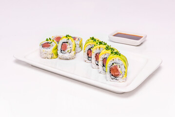  avocado uramaki with unagi sauce, on smooth-surfaced black porcelain