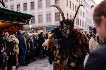 Traditional Krampuslauf parade in Germany, actors wearing scary Krampus masks and fur costumes. Alpine folklore celebration of Saint Nicholas, Bavarian winter festival, fairy-tale atmosphere