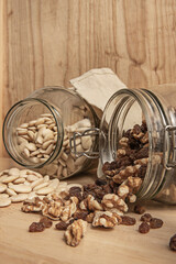 Toasted flaked almonds, seedless flame raisins, pecans, and goji berries on a copper surface