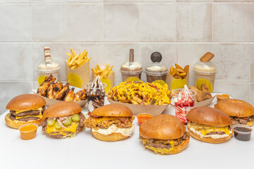 American-style still life with a juicy burger, onion rings, and BBQ sauce in a vintage bottle on a Formica countertop