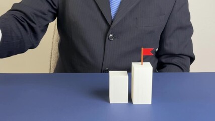 Businessman removes blocks that represent goal achievement. Business barriers, bureaucracy, and obstacles to achieving goals, symbolic representation of inefficiency and strategic failure.