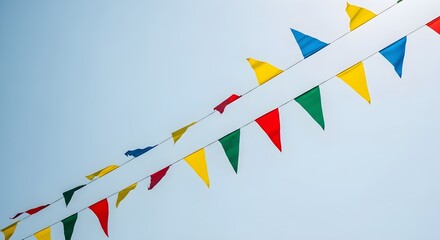 Vibrant celebratory pennant flags flutter joyfully against a clear sky, signaling festive occasions and outdoor fun