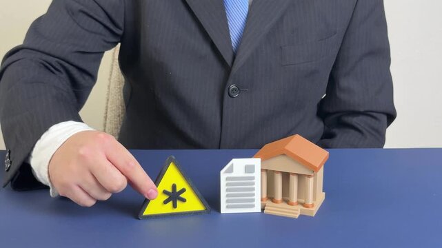 Warning about dangerous or hidden terms in banking and financial contracts fees, penalties, hidden charges, and legal risks. Businessman places a warning sign near a bank building with documents