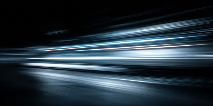 Streaks of bright blue and white light blur across a dark background.