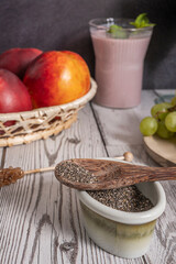 Duke variety blueberries on a dark cherry wood background and a rustic handmade ceramic spoon