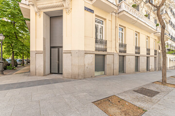 Apartment block with a lacquered aluminum composite facade and overhanging terraces with tempered glass railings