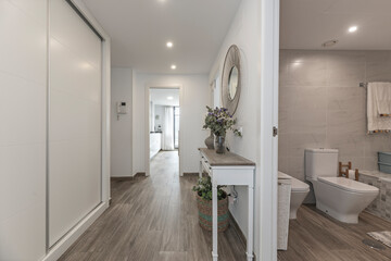 Welcoming space with an indoor wall-mounted water feature, vertical garden, and integrated natural stone bench