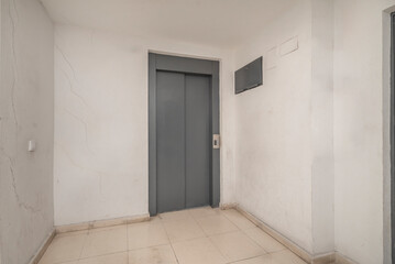 Freight and passenger elevator with capacity for 8 people and brushed steel interior paneling