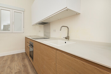 Modern kitchen integrated into the dining room, with a double-height island and Scandinavian-designed high stools in neutral tones