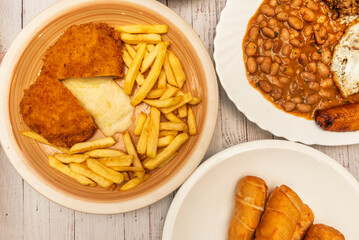 Tolimense tamales wrapped in a banana leaf with corn dough, chicken, pork, hard-boiled egg, and chickpeas, served on a handmade napkin.