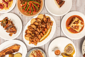 Thick Santafereno ajiaco with shredded chicken, creole and pastusa potatoes, capers, sour cream, and avocado in a clay bowl