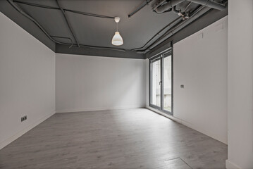 Large void space in a residential basement with exposed concrete walls and a polished concrete floor, ready for customization