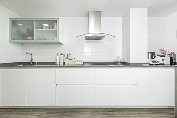  Modern kitchen with an industrial style, concrete countertops, steel shelves, and Edison filament pendant lights