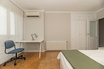 Teen bedroom with daybed, corner desk, and floating shelf for cups and other items