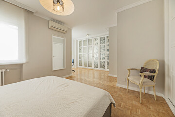Master bedroom with a minimalist superking-size bed, indirect lighting in the headboard, and floor-to-ceiling built-in wardrobes