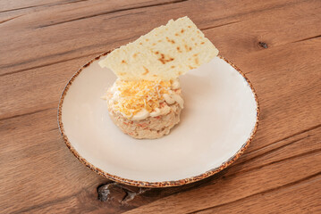 Tropical Russian salad with potatoes, mango, avocado, and shrimp, dressed with lime mayonnaise and...