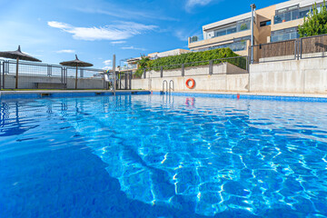 Community pool with an integrated architectural design that appears to float above the city's...