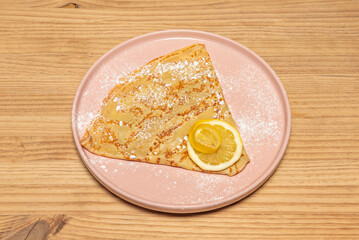 Delicious dark chocolate crepes filled with a cocoa mascarpone cream and strawberry pieces, decorated with melted chocolate and fresh mint for contrast