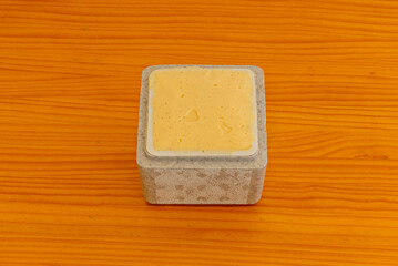 Nougat ice cream in a tub, with almond pieces and honey