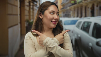 Woman smiling with arms crossed x on a street lined with parked cars and historic stone buildings; refusal.