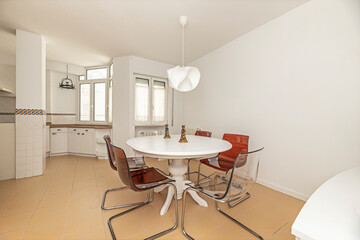 Elegant dining room with an oval   table and blue velvet chairs, ideal for formal dinners with guests