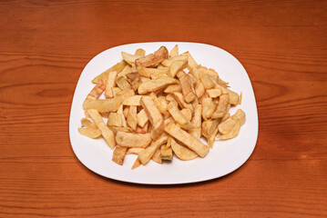 Portion of irregularly cut peasant-style fries, seasoned with fresh rosemary and garlic powder