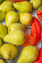 Freshly delivered shopping scene where pears, juicy red peppers, and nectarines show their freshness as they emerge from the paper bag