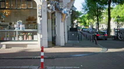 Streetscape featuring blurred urban area of european city with buildings and trees lining a cobblestone road, creating a picturesque outdoor scene enhanced by bokeh effect.