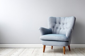 Tufted armchair rests on wooden floor against a light wall.