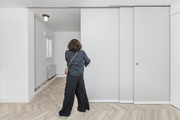 Reading room with built-in natural pine shelves, niches for decorative objects, and a Japanese rice...