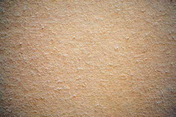 Warm beige texture with fibrous flecks, surface after removing wallpaper during renovation