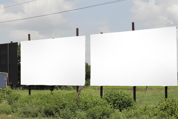 india Billboard on rural area of India, outdoor advertising, mockup billing board in front of green...