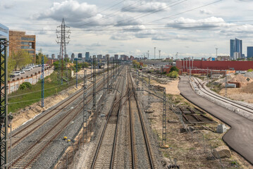 Track section at a commuter rail station with side platforms, shelters, and real-time passenger information systems.