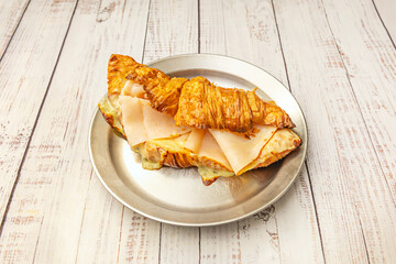 Classic croissant with creamy scrambled egg, crispy bacon, and a touch of freshly ground black pepper to start your day.
