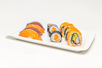 uramaki with avocado and cucumber, garnished with wasabi caviar on black porcelain