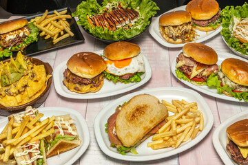 Cinematic still life with a giant movie-style burger, scattered fries, and a chocolate shake on a dramatic red velvet background